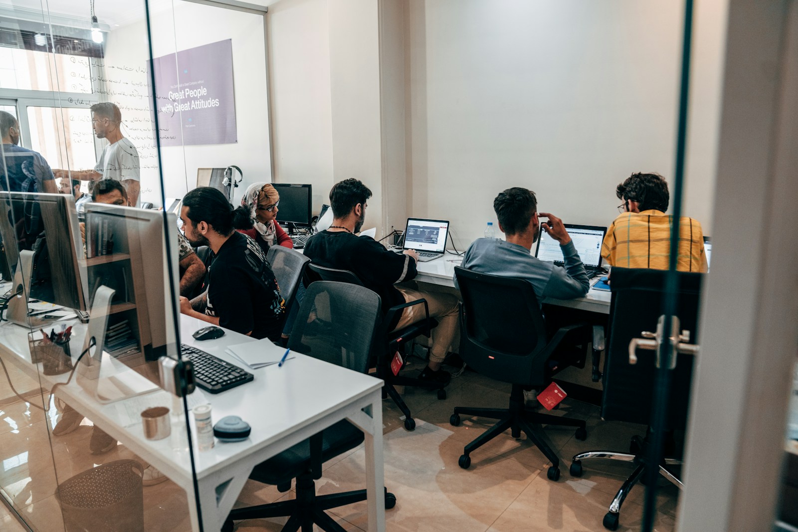 a group of people sitting at computers